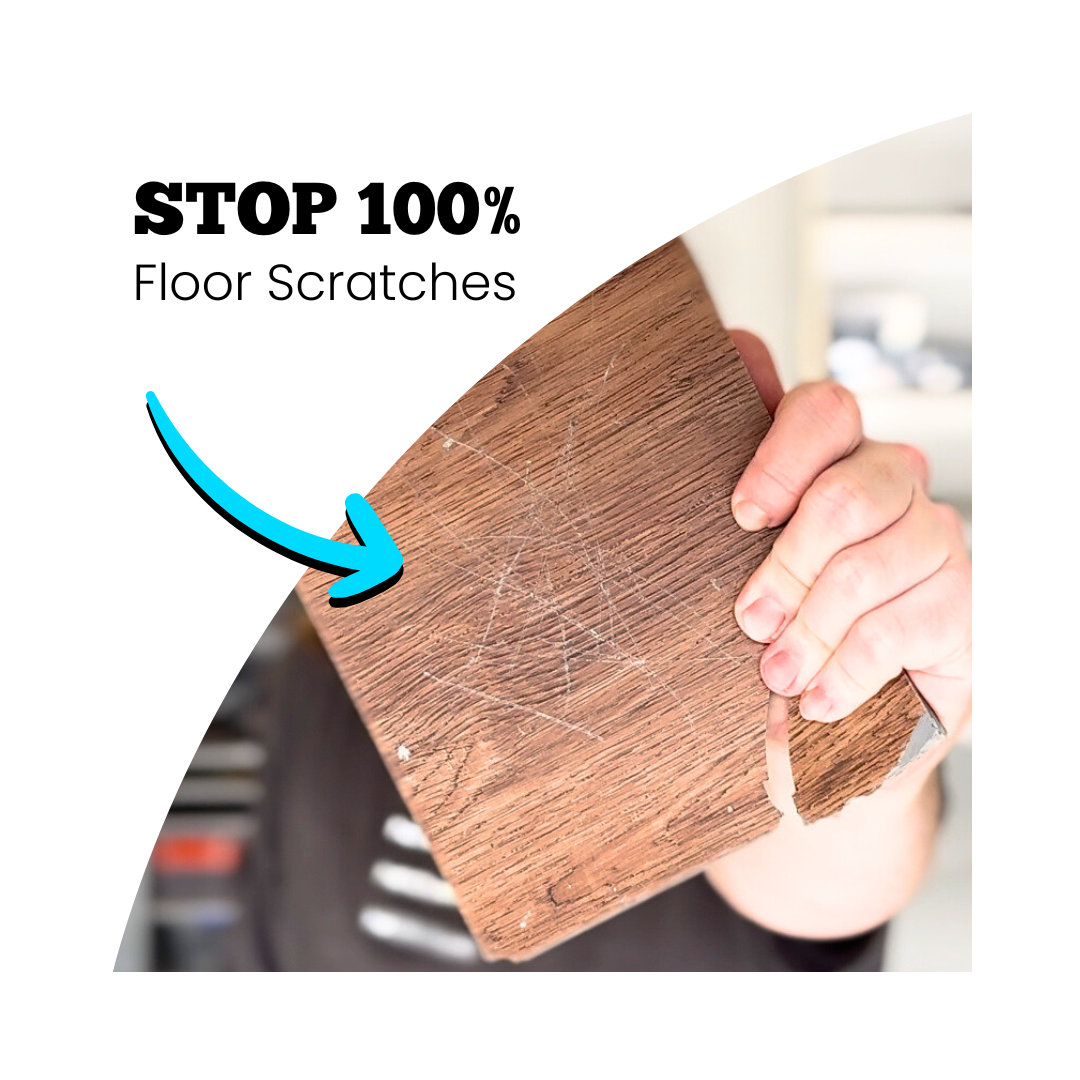 
A hand holding a scratched wooden floor sample